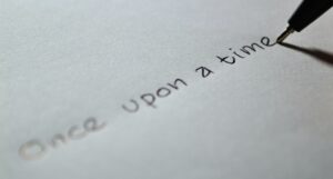 photo of a pen writing on paper