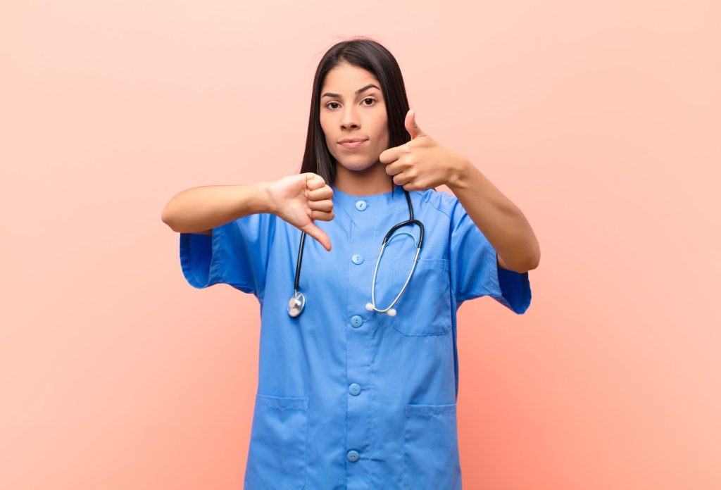 healthcare worker giving thumbs up and thumbs down 