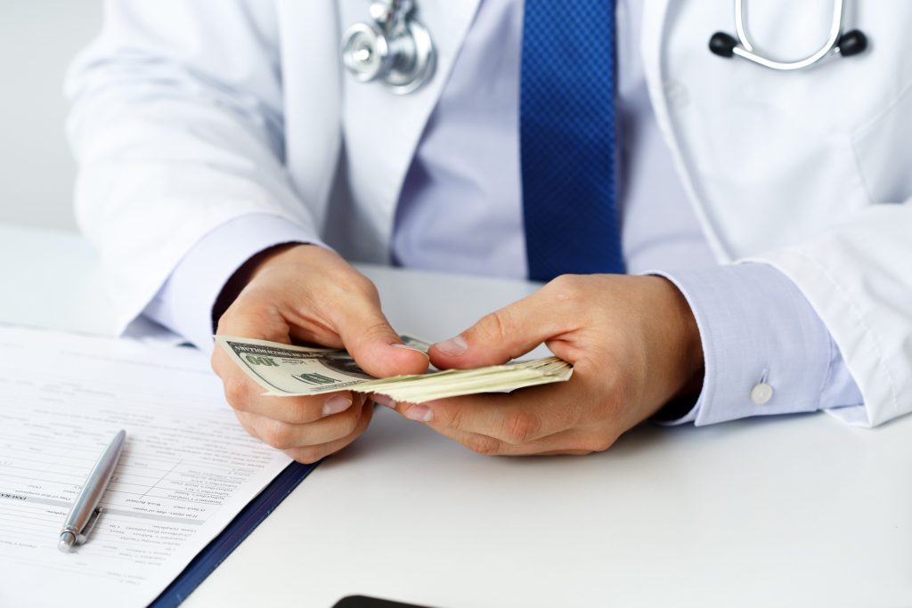Doctor holding money after being paid.