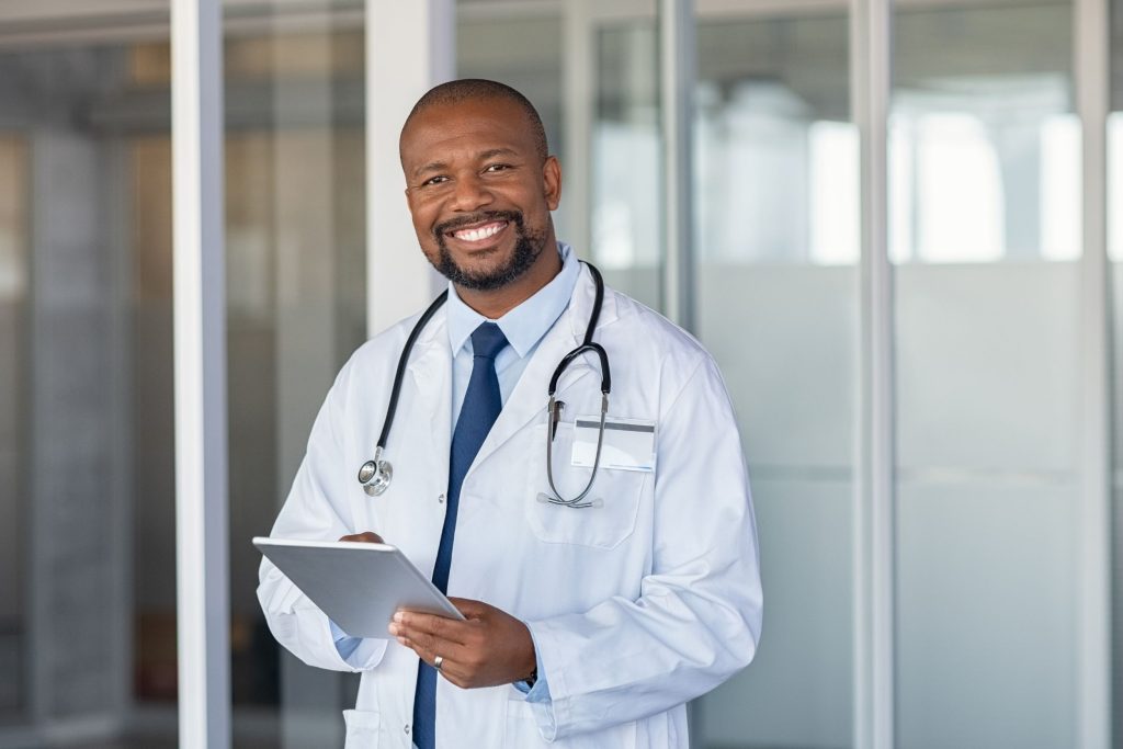 Physician holding a clipboard and smiling