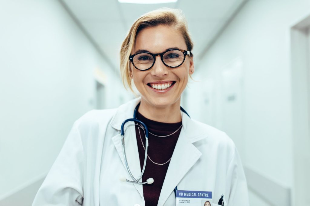 Doctor smiling in hospital corridor